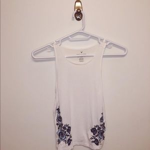 White tank top with blue floral deisgn on sides